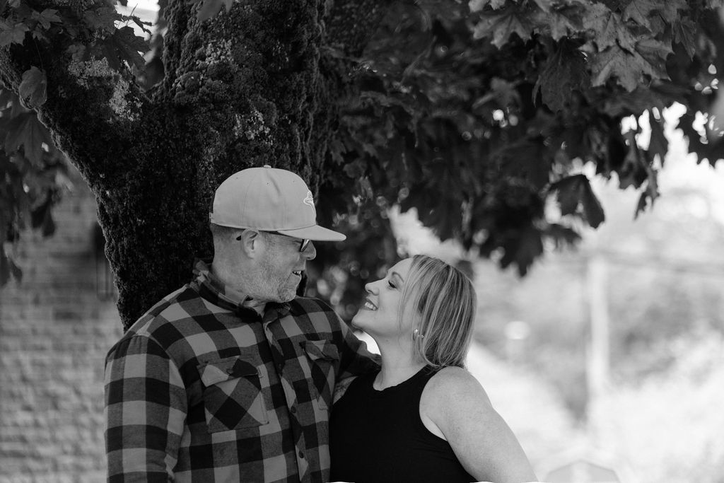 Rose laughing with her husband under a tree