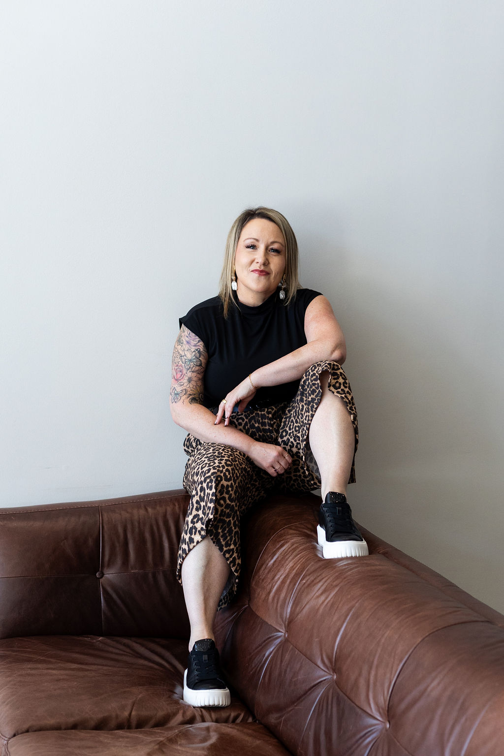 Rose Dalrymple seated on a leather couch